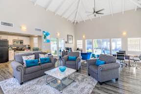 A living room with grey couches and a glass coffee table.