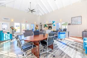 A conference room with a table and chairs.
