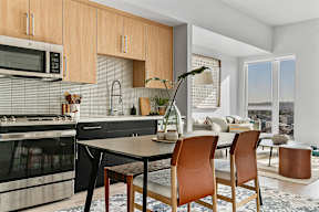 A modern kitchen with a dining table and chairs.