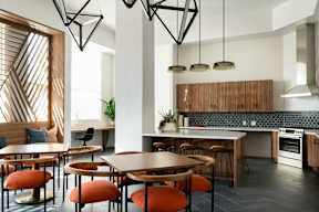 A modern kitchen with a dining table and chairs.