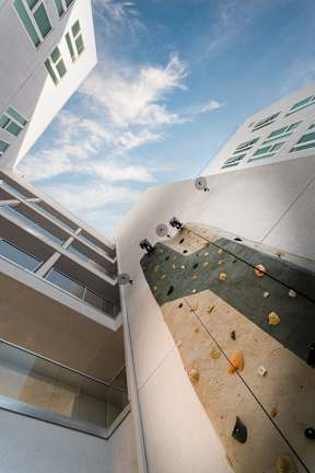 A climbing wall is attached to the side of a building.