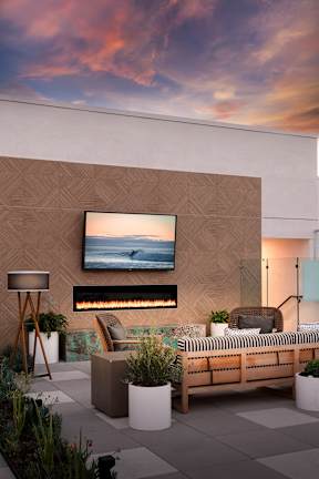 A modern outdoor living space with a flat screen TV mounted on the wall.
