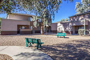 A green bench is in front of a building.