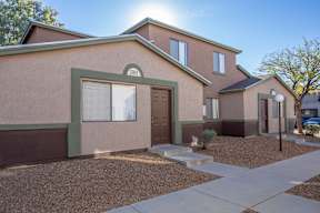 A house with brown and green exterior and a brown door.