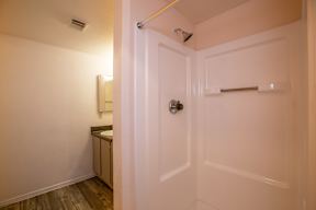 A white door with a silver handle is open.