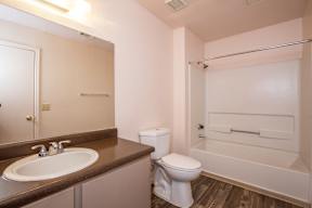 A white toilet sits next to a sink in a small bathroom.