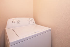 A white washing machine with a control panel on top.