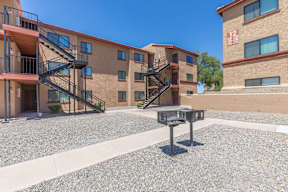 A courtyard with a mailbox in front of apartment buildings.