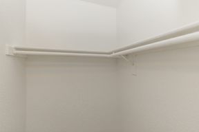 A white wall with a white shelf on top.