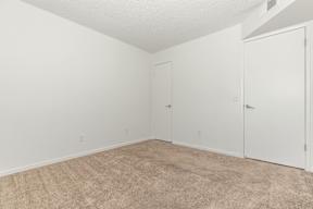 A room with carpeted floor and white walls.
