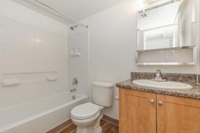 A white toilet sits next to a sink in a bathroom.