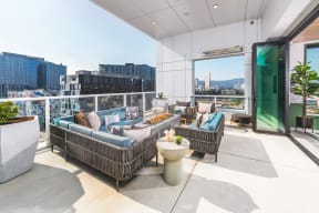 Rooftop lounge with outdoor couches and views of Portland, Oregon
