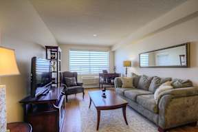 A living room with a couch, chair, and coffee table.