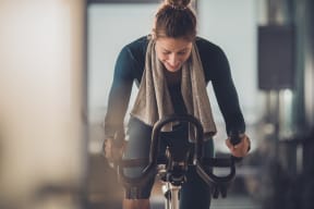 a woman riding a bike in a gym