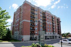 a brick apartment building with a sign in front of it