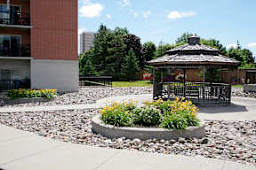 a gazebo in the middle of a rock garden