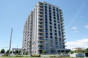A tall residential building with balconies on each floor.