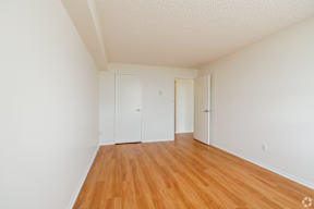 A room with wooden floors and white walls.