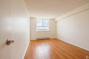 A room with a wooden floor and a window.