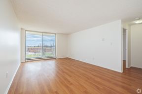 Empty room with wooden floor and white walls.