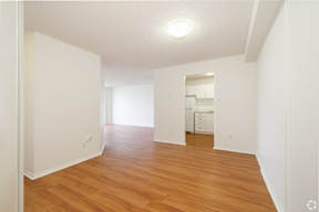 A room with wooden floors and white walls.