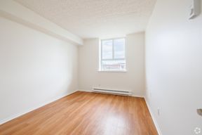 A room with a window and a radiator on the wall.