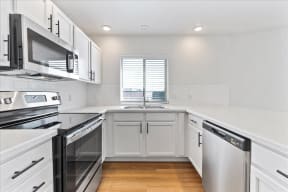 Kitchen with appliances, cabinets and counter top at River Walk Apartments, Idaho
