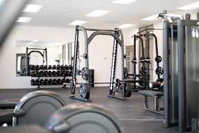 A gym with a variety of equipment including weights and weight machines.at Copestone Apartments, Garden City, ID 59808
