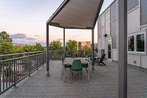 A wooden deck with a table and chairs.at Copestone Apartments, Idaho, 59808