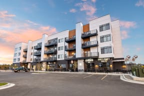 an exterior view of a large apartment building with a parking lot in front of it at Shiloh Commons, Billings Montana