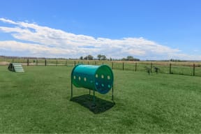 a large grassy field with a green mailbox in the middle of it at InterUrban Apartments, Billings