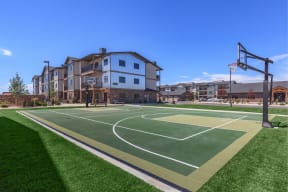 a basketball court at the whispering winds apartments in pearland, tx