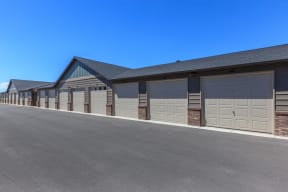 a row of garages with a blue sky in the background at InterUrban Apartments, Montana