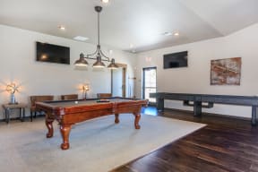 a game room with a pool table and a foosball table at InterUrban Apartments, Montana