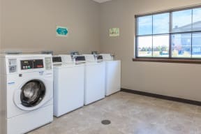 a laundry room with washers and dryers at InterUrban Apartments, Billings Montana