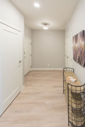a long hallway with a table and chairs at Shiloh Commons, Montana, 59102