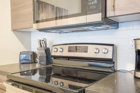 a kitchen with a stove and microwave at Shiloh Commons, Billings, 59102