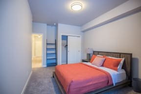 a bedroom with a bed and stairs to a bathroom at Shiloh Commons, Montana, 59102