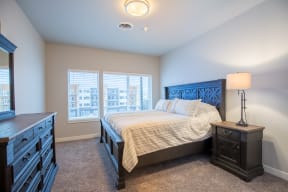 a bedroom with a bed and a dresser at Shiloh Commons, Billings Montana