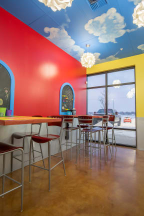 a brightly colored restaurant with clouds painted on the ceiling at Shiloh Commons, Billings, 59102