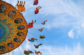 people riding on a ferris wheel at an amusement park