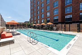 A pool with a white and blue border and a white and black border with the words