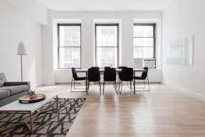 Living room and dining room space with large windows
