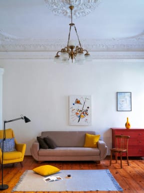 a living room with a couch and a chandelier