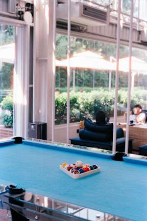A pool table with a rack of balls on it.