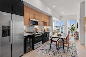 A modern kitchen with a dining table and chairs.