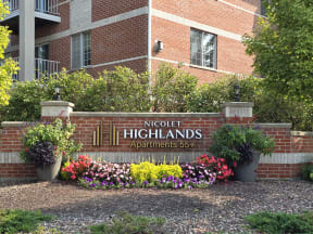 a brick wall with flowers in front of a building