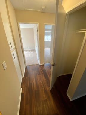 Hallway closet, linen closet and bedrooms view at Grande Vista Apartments.