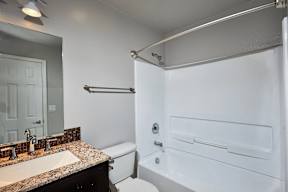 A white bathroom with a sink, toilet, and bathtub.