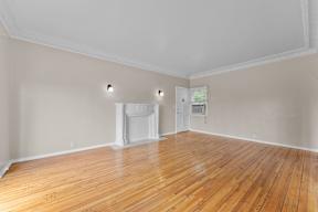 A room with wooden floors and white walls.